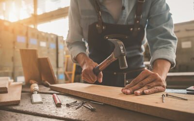 carpenter-working-with-equipment-wooden-table-carpentry-shop_1418-2326